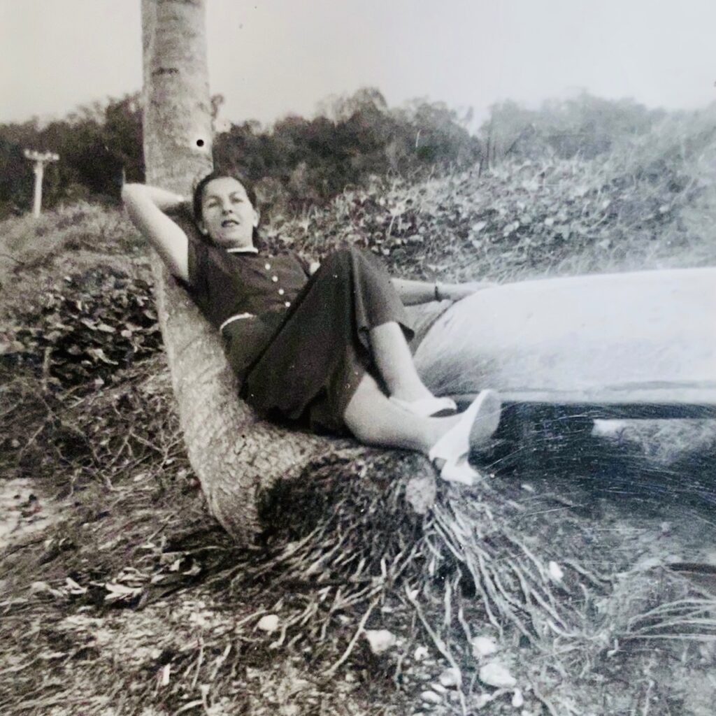 PhyllisReclining on a coconut trunk with my hand on a fishing canoe probably a dug-out cotton tree