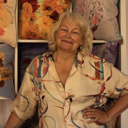 Georgina von Etzdorf in her shop in Wilton with some of her colourful cushions