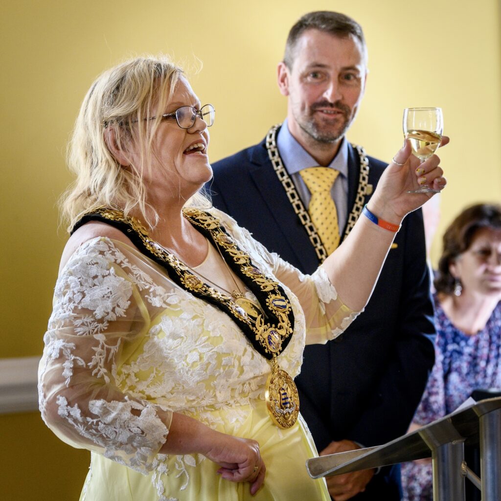 Raising a glass with husband Tom at a mayoral reception