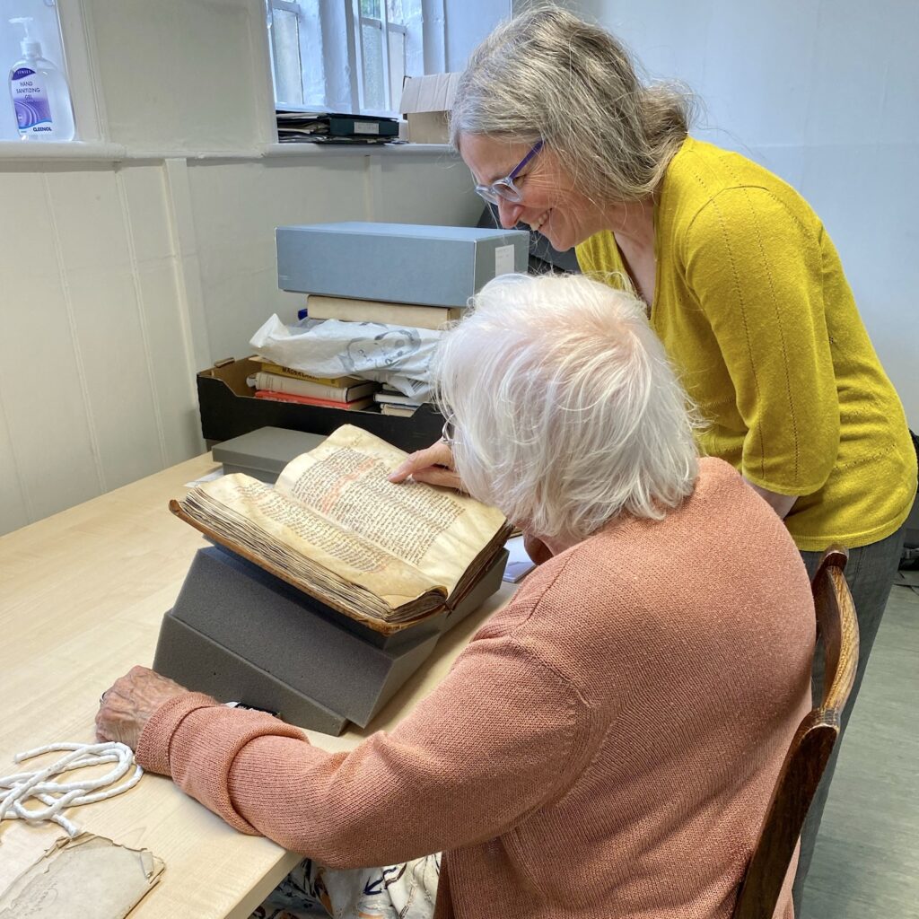 Emily working with a volunteer in the archive